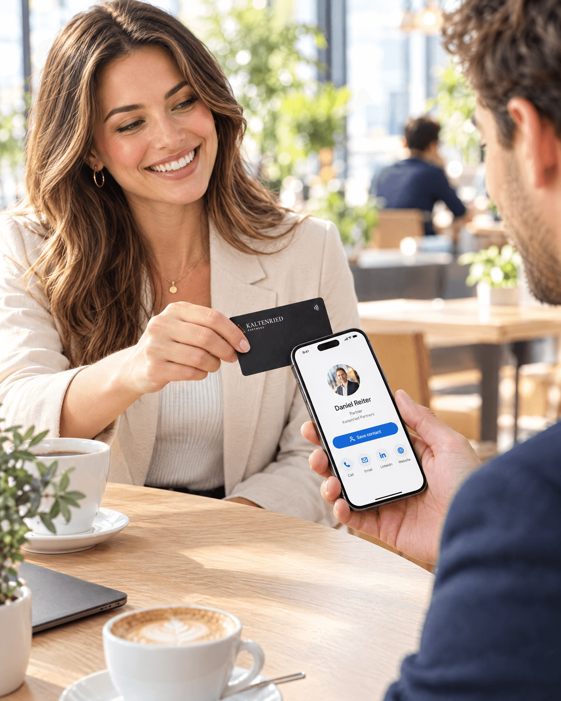 Woman tapping her Tapni card on a friend's phone in a café